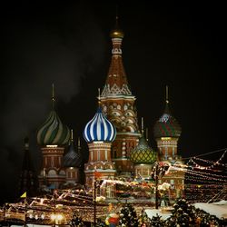 Illuminated building against sky at night