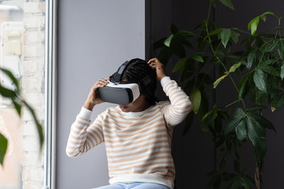 Girl in vr headset watch video or play game for entertainment at home wear virtual reality goggles