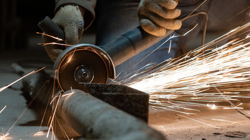 Low angle view of man working on metal