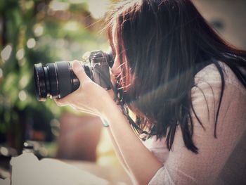 Portrait of woman photographing