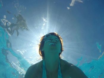 Low angle view of woman swimming in sea