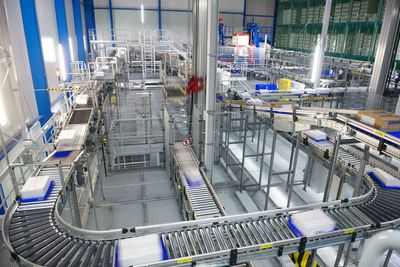 Automated warehouse. boxes with spare parts moving on conveyer