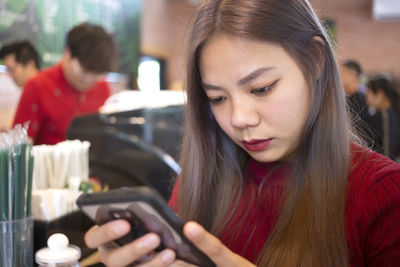 Portrait of young woman using mobile phone