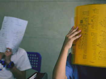 Midsection of woman reading book