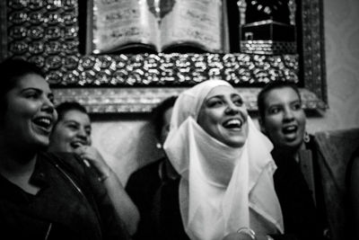 Portrait of smiling young woman in city