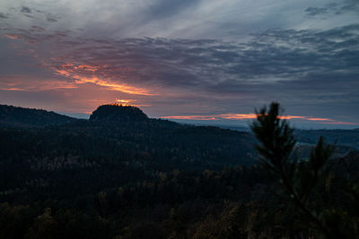 Scenic view of silhouette mountains against sky at sunset