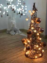 Close-up of illuminated christmas lights on table at home