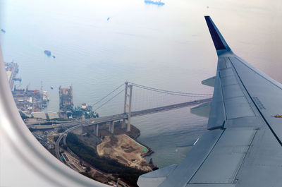 Aerial view of city against sky seen through airplane window