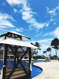 View of swimming pool by sea against sky