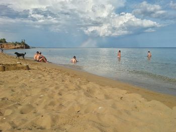 View of beach against cloudy sky