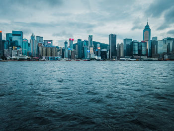 Sea and cityscape against sky