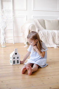Girl lying on hardwood floor at home