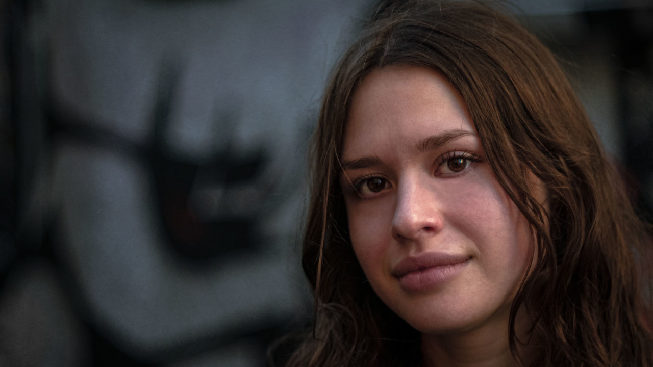 portrait, female, person, one person, headshot, human face, adult, women, portrait photography, long hair, close-up, emotion, smiling, hairstyle, young adult, human head, human hair, brown hair, looking at camera, human eye, serious, teenager, focus on foreground, looking, photo shoot, depression - sadness, loneliness, lifestyles, contemplation, nose, skin, city