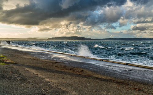 A view of the shoreline on a stormy day at alki beach in west seattle, washington.