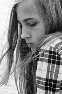 Close-up portrait of a beautiful young woman in background