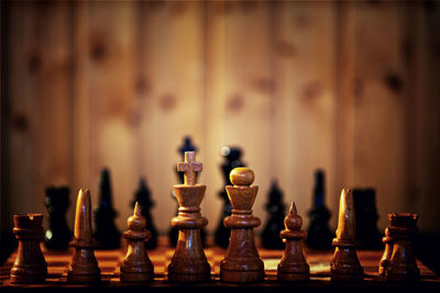Close-up of wooden chess pieces on board