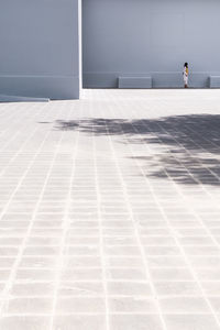 Sunlight falling on wall by swimming pool against building