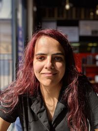 Portrait of smiling teenage girl in cafe