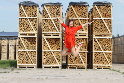 Portrait of woman standing against built structure