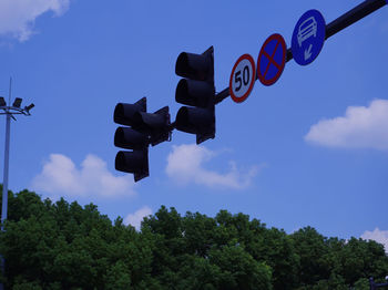 Low angle view of road sign against sky