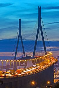 View of suspension bridge against cloudy sky