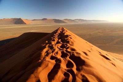 Close-up of sand dune over valley