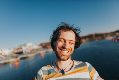 Smiling man with sea in background