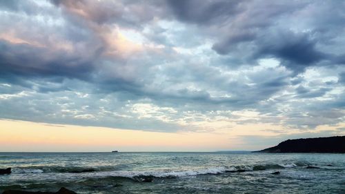 Scenic view of sea against cloudy sky