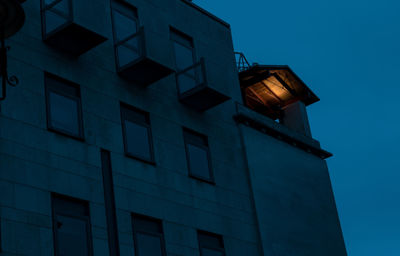 Low angle view of illuminated building against sky at dusk
