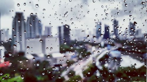 Close-up of wet glass window in rainy season