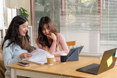 Businesswoman using laptop at office