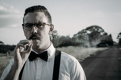 Portrait of man holding cigar