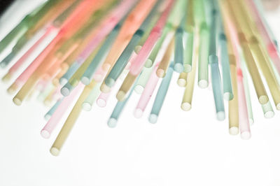 Close-up of colored pencils over white background