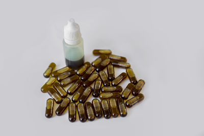 High angle view of bottles on table against white background