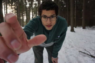 Portrait of young man exercising on snow