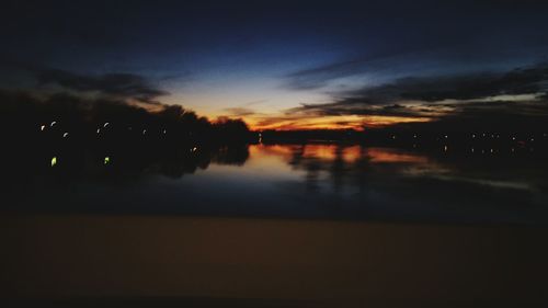 Scenic view of lake at sunset