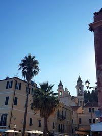 Low angle view of bell tower against blue sky