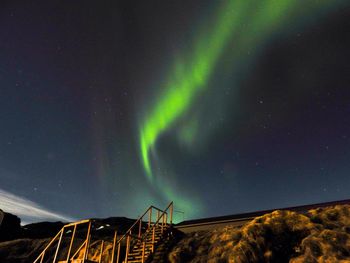 Low angle view of landscape against sky at night