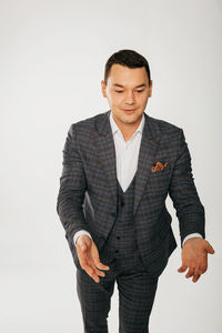 Young man standing against white background