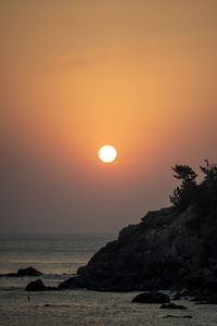 Scenic view of sea against orange sky