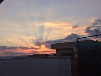 Built structure against cloudy sky at sunset