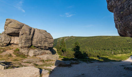 Rock formations on landscape against sky