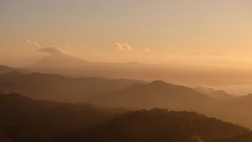 Scenic view of silhouette mountains against sky at sunset