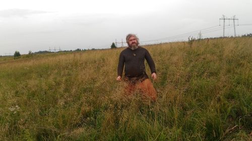 Portrait of man on field against sky