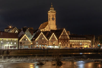 Reflection of illuminated buildings in city at night