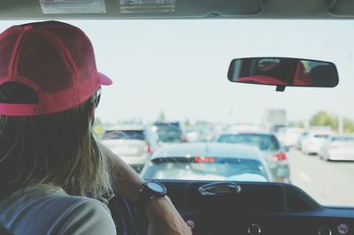 Rear view of woman sitting in car