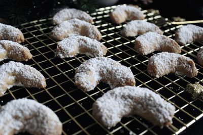 Handmade vanilla crescents on gold cooling grid