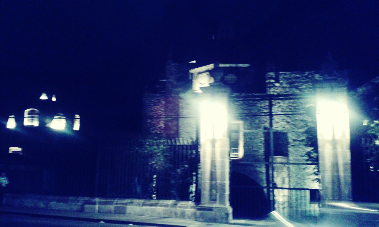 LOW ANGLE VIEW OF ILLUMINATED BUILDINGS AT NIGHT