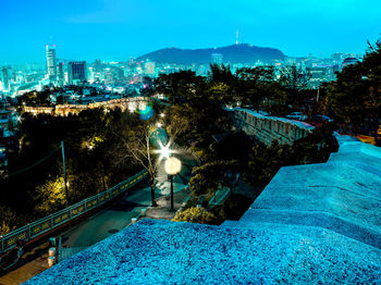 Illuminated cityscape against sky at night