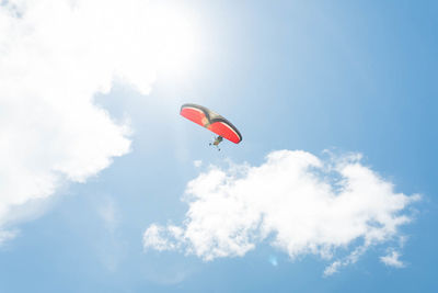 Low angle view of paragliding against sky